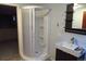 Modern bathroom featuring a corner shower and a sleek vanity with a contemporary sink and storage at 12381 E Vassar Dr, Aurora, CO 80014