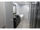 Chic bathroom with vessel sinks, modern vanity, luxurious tub, and modern lighting at 12381 E Vassar Dr, Aurora, CO 80014