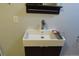 Modern bathroom with a square sink and dark vanity, with shelf and faucet at 12381 E Vassar Dr, Aurora, CO 80014
