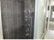 Bathroom shower with modern tile and a sleek multi-setting shower panel at 12381 E Vassar Dr, Aurora, CO 80014