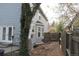 Exterior of a blue home with double doors, a patio, and mature trees at 12381 E Vassar Dr, Aurora, CO 80014