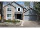Charming two-story home with brick and blue siding, a well-manicured lawn, and a two-car garage at 12381 E Vassar Dr, Aurora, CO 80014