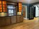 Kitchen area with granite countertops, custom cabinets, pendant lighting, and wood flooring at 12381 E Vassar Dr, Aurora, CO 80014