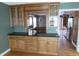 Gourmet kitchen featuring custom wood cabinets, granite countertops, and view into dining room at 12381 E Vassar Dr, Aurora, CO 80014
