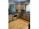 Well-equipped kitchen featuring stainless steel appliances, wood cabinets, and granite countertops at 12381 E Vassar Dr, Aurora, CO 80014