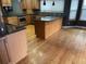 Spacious kitchen featuring stainless steel appliances, breakfast bar, and wood flooring at 12381 E Vassar Dr, Aurora, CO 80014