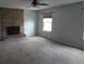 Living room features a brick fireplace, ceiling fan, neutral colors, and plush carpeting at 12381 E Vassar Dr, Aurora, CO 80014