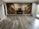 Bright living room with modern flooring and a unique fireplace feature wall at 12381 E Vassar Dr, Aurora, CO 80014