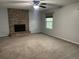 Cozy living room featuring a brick fireplace and a large window at 12381 E Vassar Dr, Aurora, CO 80014