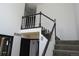 An impressive staircase with dark railings, new carpet, and natural light from above at 12381 E Vassar Dr, Aurora, CO 80014