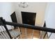 View from top of stairwell towards front door, featuring a modern chandelier and wooden floors at 12381 E Vassar Dr, Aurora, CO 80014