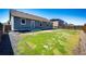 The large backyard is well-maintained with back entrance and a metal railing covered deck at 56607 E 23Rd Ave, Strasburg, CO 80136