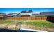 Spacious backyard features a wood fence, solar panels, and ample space for outdoor activities at 56607 E 23Rd Ave, Strasburg, CO 80136