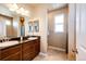 Bathroom boasts double sinks, granite countertops, large mirrors, and plenty of storage space at 56607 E 23Rd Ave, Strasburg, CO 80136