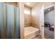 Bathroom with tub, tile surround, and a window provides natural light, creating a spa-like experience at 56607 E 23Rd Ave, Strasburg, CO 80136