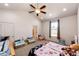 Bright, spacious bedroom with ample play area, multiple windows, and neutral walls at 56607 E 23Rd Ave, Strasburg, CO 80136