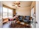 Sun-lit bedroom with beautiful wood floors, and a cozy sitting area and large window overlooking front yard at 56607 E 23Rd Ave, Strasburg, CO 80136