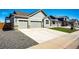 Charming home with a long concrete driveway and a two car garage at 56607 E 23Rd Ave, Strasburg, CO 80136