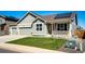 Charming single-Gathering home features a well-manicured lawn, stone accents, solar panels, and a covered front porch at 56607 E 23Rd Ave, Strasburg, CO 80136