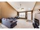 Bright living room featuring vaulted ceilings, neutral carpet, a large window, and a comfortable couch at 56607 E 23Rd Ave, Strasburg, CO 80136
