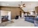 Open-concept living room with vaulted ceilings, ceiling fan, and seamless transition into the dining and kitchen area at 56607 E 23Rd Ave, Strasburg, CO 80136