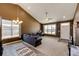 Open-concept living room features plush carpet, high ceilings, lots of natural light, and modern decor at 56607 E 23Rd Ave, Strasburg, CO 80136