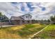 Spacious backyard with brick and vinyl siding, a wooden fence, grass, and a deck at 19033 E 22Nd Cir, Aurora, CO 80011