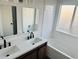 Bright bathroom features a double sink vanity, a shower-tub combination, and white tile at 19033 E 22Nd Cir, Aurora, CO 80011