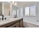 Bright bathroom with double vanity, quartz countertops, and modern fixtures at 19033 E 22Nd Cir, Aurora, CO 80011