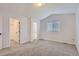 Bright bedroom featuring neutral carpet, walk-in closet, and natural light at 19033 E 22Nd Cir, Aurora, CO 80011