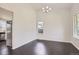 Bright dining room featuring wood floors, modern chandelier, and natural light at 19033 E 22Nd Cir, Aurora, CO 80011