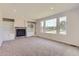 Spacious living room featuring a fireplace, built-in shelving, and large windows at 19033 E 22Nd Cir, Aurora, CO 80011