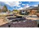 Landscaped backyard with a pond, wooden bridge, and rock features at 3411 S Olathe Way, Aurora, CO 80013