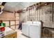 Unfinished basement laundry area with washer and dryer at 3411 S Olathe Way, Aurora, CO 80013