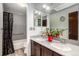 This bathroom features double sinks, a large mirror, and a shower with a curtain at 3411 S Olathe Way, Aurora, CO 80013