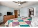 This bedroom features a ceiling fan and a wooden dresser with a TV on top at 3411 S Olathe Way, Aurora, CO 80013