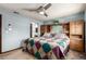 Bright bedroom featuring a built-in headboard, soft blue walls and neutral carpet at 3411 S Olathe Way, Aurora, CO 80013