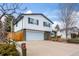 Inviting split-level home with attached garage, brick accents, and landscaped front yard at 3411 S Olathe Way, Aurora, CO 80013