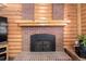 Close up on a fireplace in a cozy living room featuring a wood-burning fireplace and brick accents at 3411 S Olathe Way, Aurora, CO 80013