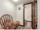 Hallway featuring a chair, wooden bench, and a door to the bathroom at 3411 S Olathe Way, Aurora, CO 80013