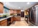 Charming kitchen featuring wood cabinets, stainless steel appliances and a modern design at 3411 S Olathe Way, Aurora, CO 80013