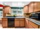 Bright kitchen featuring wood cabinets and modern appliances at 3411 S Olathe Way, Aurora, CO 80013