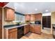 Cozy kitchen with wooden cabinets, laminate countertops and black appliances at 3411 S Olathe Way, Aurora, CO 80013