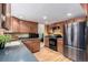 Charming kitchen featuring wood cabinets, stainless steel appliances and a modern design at 3411 S Olathe Way, Aurora, CO 80013