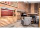 Cozy living room featuring a wood-burning fireplace, beamed ceilings, and comfortable seating at 3411 S Olathe Way, Aurora, CO 80013