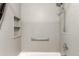 The shower features a hand-held shower head, grab bar, and built-in shelving at 3411 S Olathe Way, Aurora, CO 80013