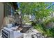 Backyard patio area featuring a stone fire pit, lounge seating, and landscape at 4321 Winona Ct, Denver, CO 80212