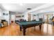 Finished basement offering a pool table, hardwood floors, and access to a living area at 4321 Winona Ct, Denver, CO 80212