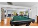 Bright basement featuring a pool table, hardwood floors, and a comfortable seating area at 4321 Winona Ct, Denver, CO 80212