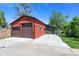 Detached two-car garage with modern doors and a wide driveway offers ample parking space at 4321 Winona Ct, Denver, CO 80212